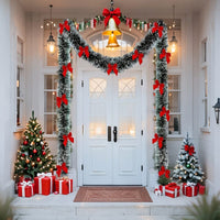 Guirlande de Noël enneigée avec nœuds rouges servant de déco à la devanture d'une maison. 